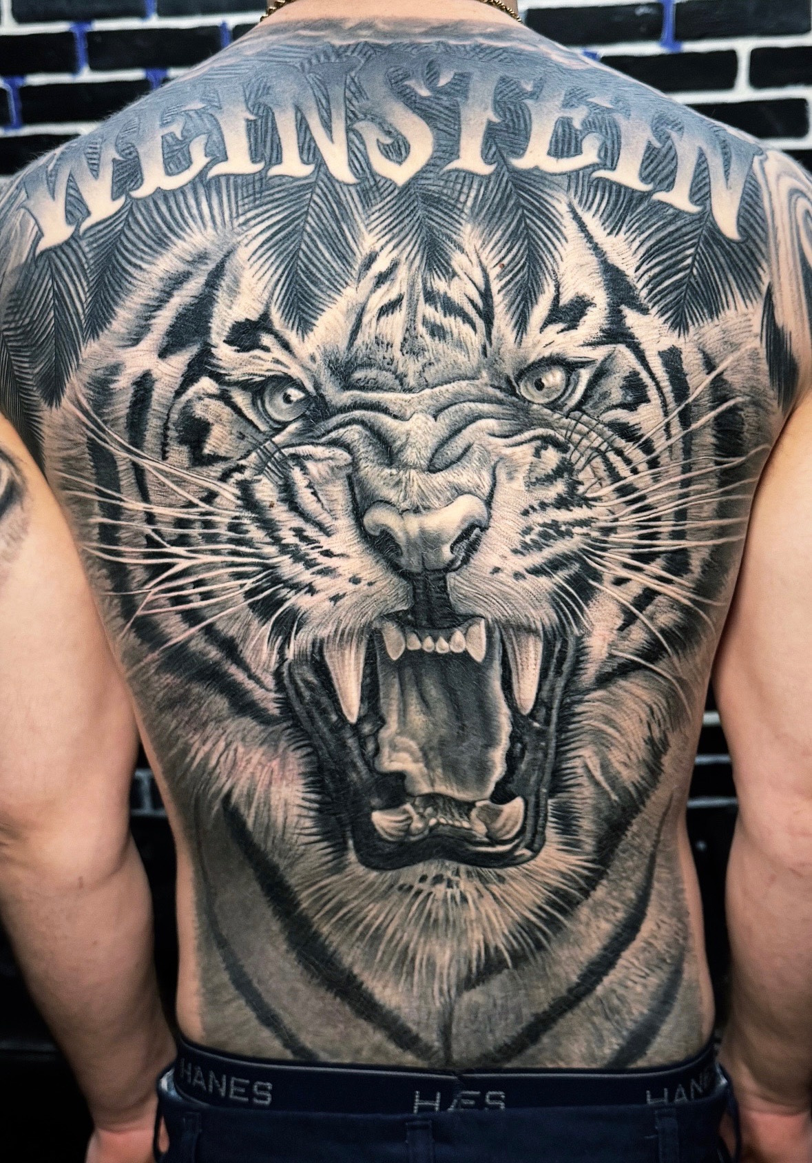 Black and grey roaring lion back tattoo by Maverick Mayes